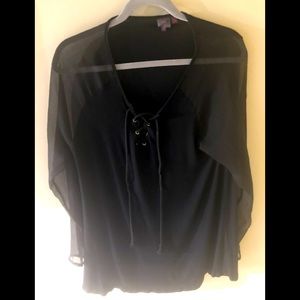 A black classic blouse with sheer sleeves and back